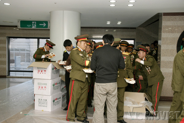 '여기, 정말 북한 아니야?...'  인민군 복장의 배우들이 저녁 식사를 위해 배급받는 모습이 이채롭다.